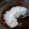 mixing gf dry ingredients into melted chocolate mixture