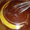 whisking melted chocolate into egg mixture.
